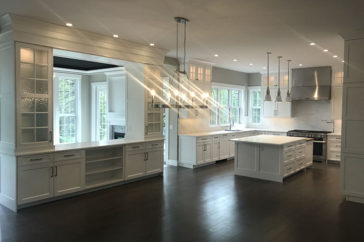 Bright white custom kitchen with pendant and pot lighting
